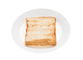 Slices toast bread in dish on white background photo