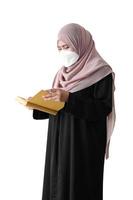 Muslim girl reading religion book on white background