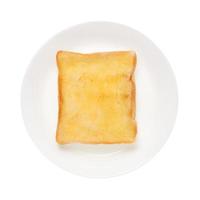 Slices toast bread in dish on white background photo