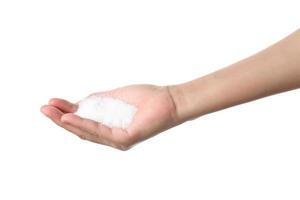 Hand holding sugar on white background photo