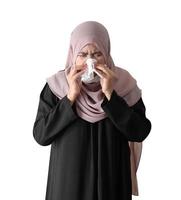 Muslim woman feeling sick standing on white background. Covid-19 coronavirus concept. photo