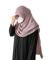 Muslim woman feeling sick standing on white background. Covid-19 coronavirus concept. photo