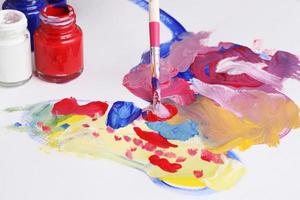 Asian boy use paintbrush and watercolor painting in paper photo