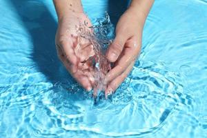 Woman washing hands in water to clear respiratory bacteria and viruses. photo