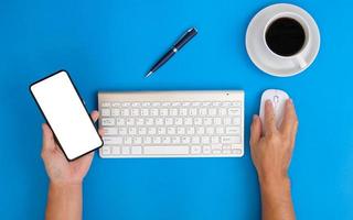 Hands of a man working on a modern laptop Banking and money themes on a blue background in an office. photo