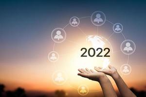 Tendencias de negocios de metaverso de conexión en línea en 2022, mano que sostiene el mundo de la red de tecnología de Internet.