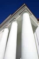 White columns against clear blue sky photo