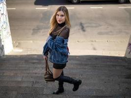 blonde girl stands on the stairs photo