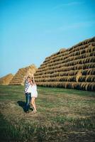 a guy with a girl on a summer walk in the field photo