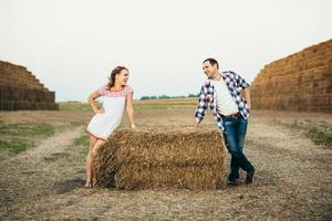 a guy with a girl on a summer walk in the field photo