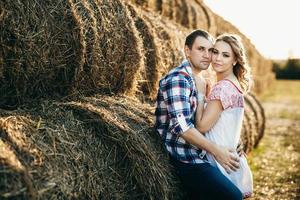 a guy with a girl on a summer walk in the field photo