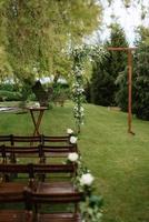 wedding ceremony area with dried flowers in a meadow in a forest photo