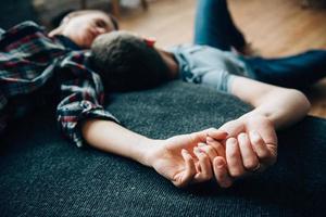 a guy and a girl lie on the bed in the room photo