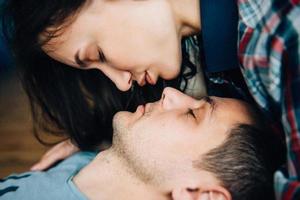 a guy and a girl lie on the bed in the room photo