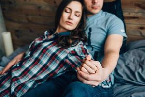 a guy and a girl lie on the bed in the room photo