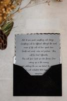 wedding invitation in a gray envelope on a table photo