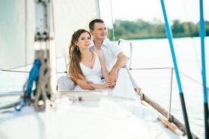 young couple guy and girl on a sailing yacht photo