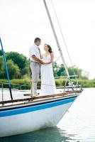 young couple guy and girl on a sailing yacht photo