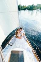 young couple guy and girl on a sailing yacht photo