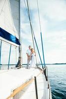 young couple guy and girl on a sailing yacht photo