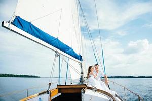 young couple guy and girl on a sailing yacht photo