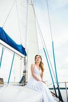 young girl on deck of sailing wooden yacht photo