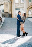 guy and a girl happily walk in the morning on the empty streets photo