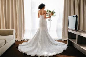 bride in a white dress with a bouquet photo