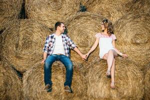 a guy with a girl on a summer walk in the field photo