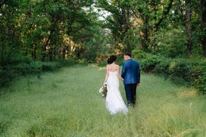 A couple in love a guy and a girl on a walk in the forest belt photo