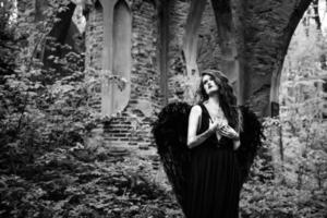 Fallen angel with black wings photo