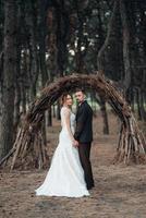 walk of the bride and groom through the autumn forest photo