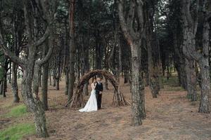 walk of the bride and groom through the autumn forest photo