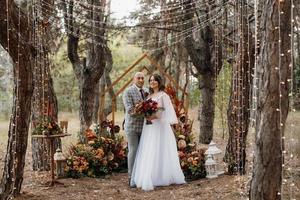 man and woman got engaged in autumn forest photo