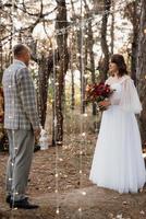 man and woman got engaged in autumn forest photo