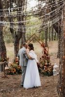 man and woman got engaged in autumn forest photo