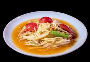 Spicy Thai Papaya Salad in the white plate photo