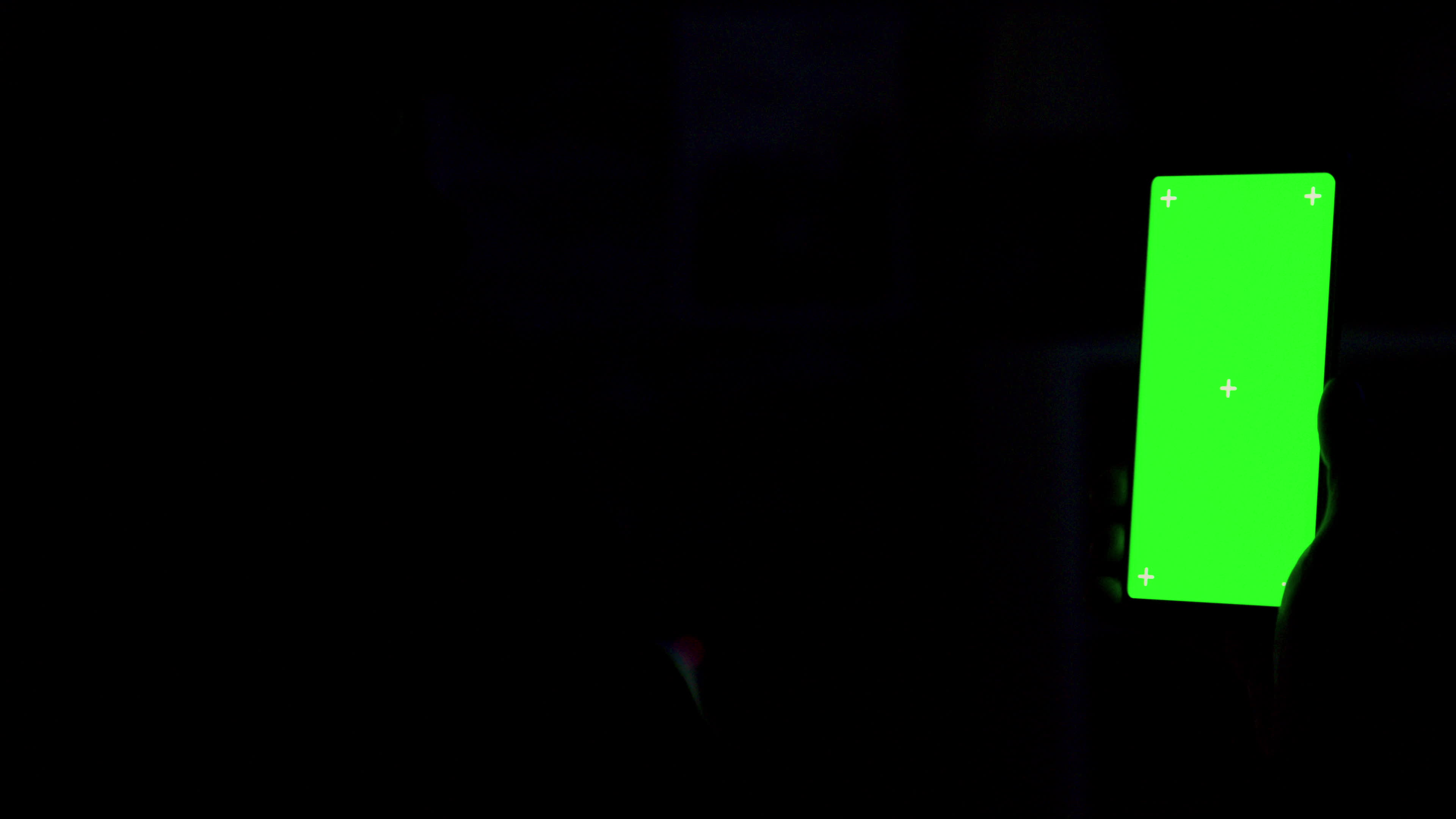 Using a smartphone with green screen in dark room at night 4738786