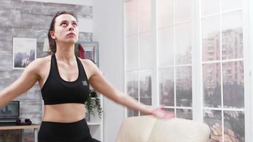 Young woman relaxing at home in living room video