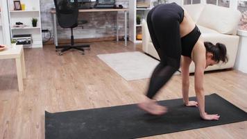 chica deportiva haciendo un ejercicio de yoga en casa