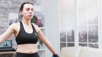 Young woman doing lunges forward in living room video