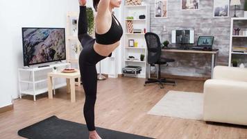 Young woman doing a yoga balancing exercise video