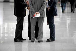 Four businessmen are negotiating in a circle photo