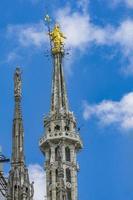 Statue of the Virgin Mary on top of Milan Cathedral Duomo di Milano in Italy photo