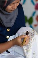 Indonesia, December 2021 - Young Woman doing batik photo