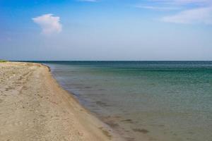 Seascape with sandy beach on the background of the sea. photo