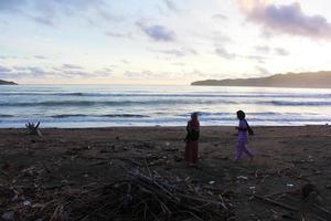 Indonesia 2021 - A couple playing on the beach at the sunset time photo