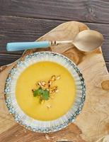 Creamy pumpkin soup with herbs and pumpkin seeds. French gourmet food photo