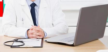 Portrait of senior doctor in medical office photo