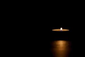 Candle lighting the dark. Darkness, Memorial, Hope. photo